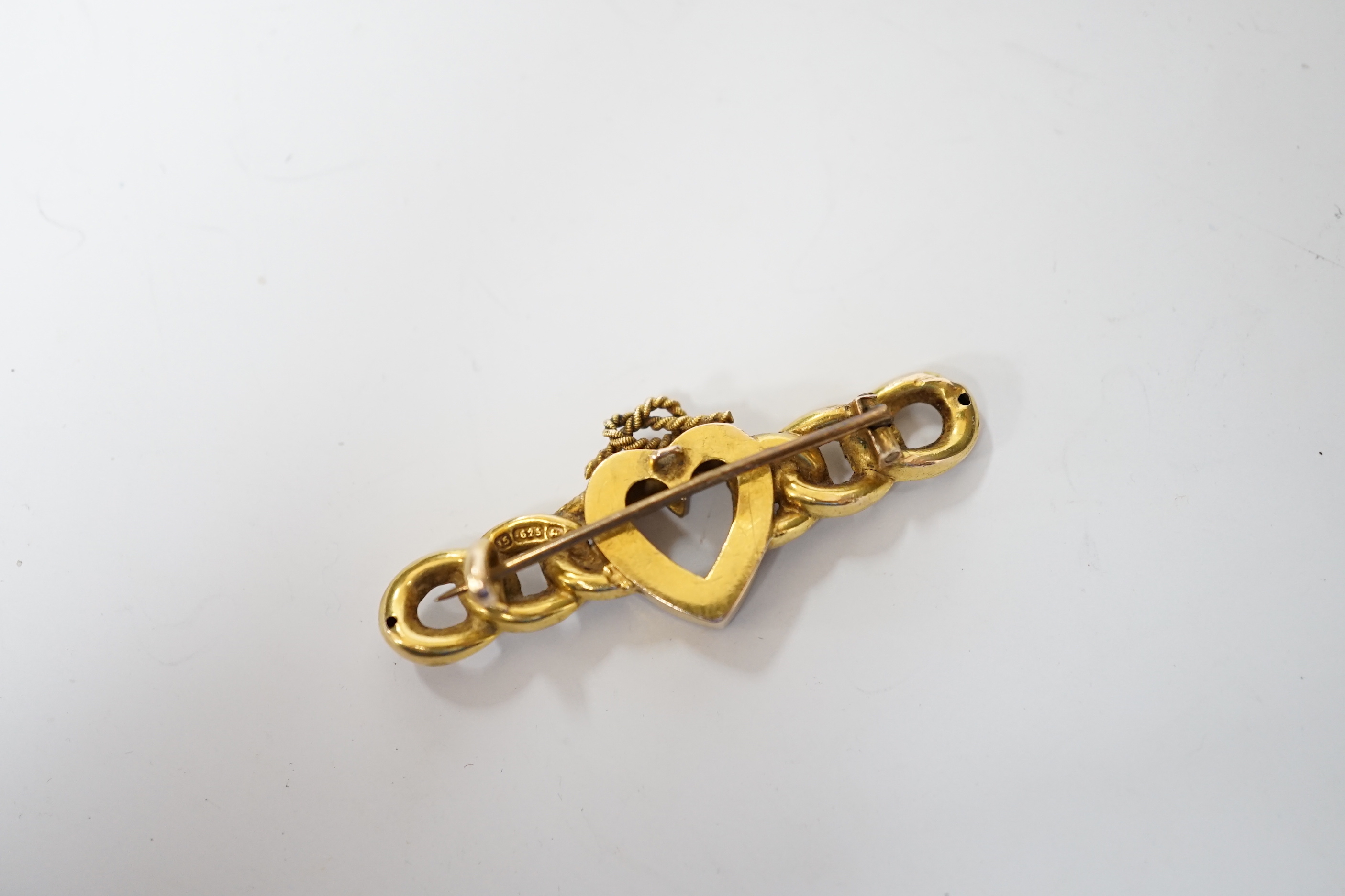 A late Victorian 15ct gold and seed pearl set bar brooch, with central heart with knot motif, 43mm, gross weight 3.8 grams.